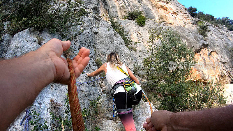 女人爬陡峭的岩石路线