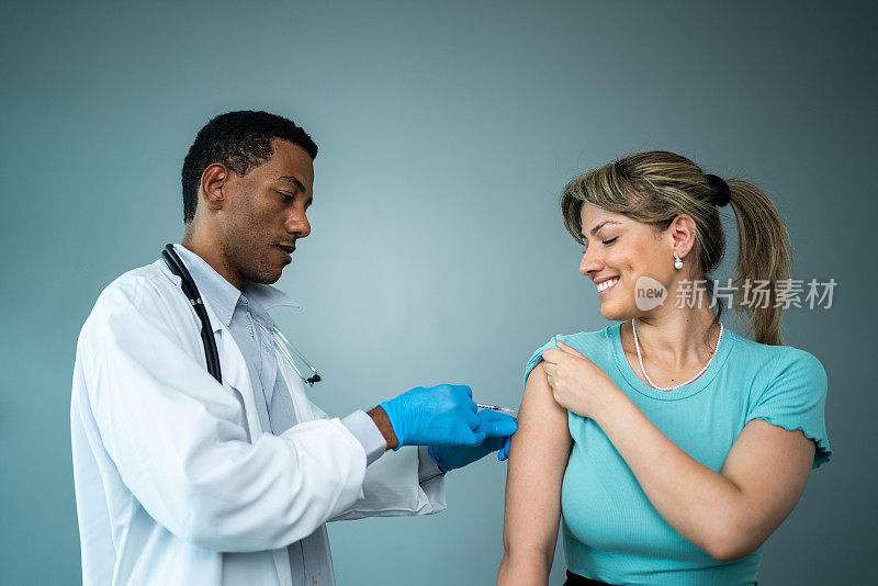 医生正在给一名年轻女子接种疫苗