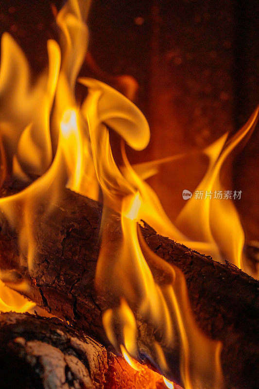火焰覆盖着壁炉中燃烧的原木