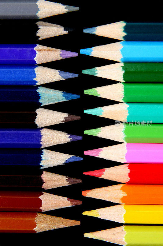 不同颜色的铅笔在黑色的表面