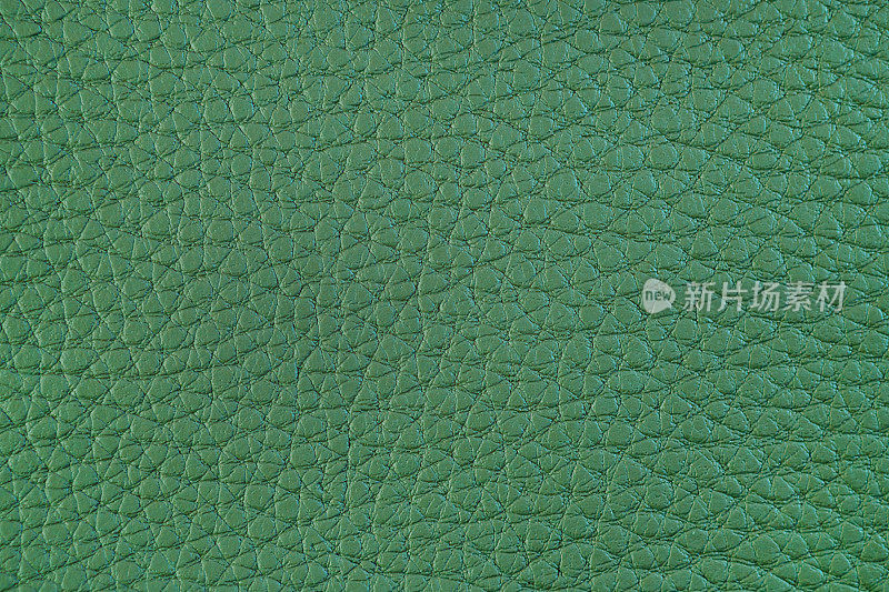 人造皮革的质地。亮绿色背景。