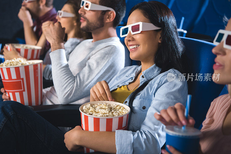 带着3d眼镜和爆米花一起在电影院看电影