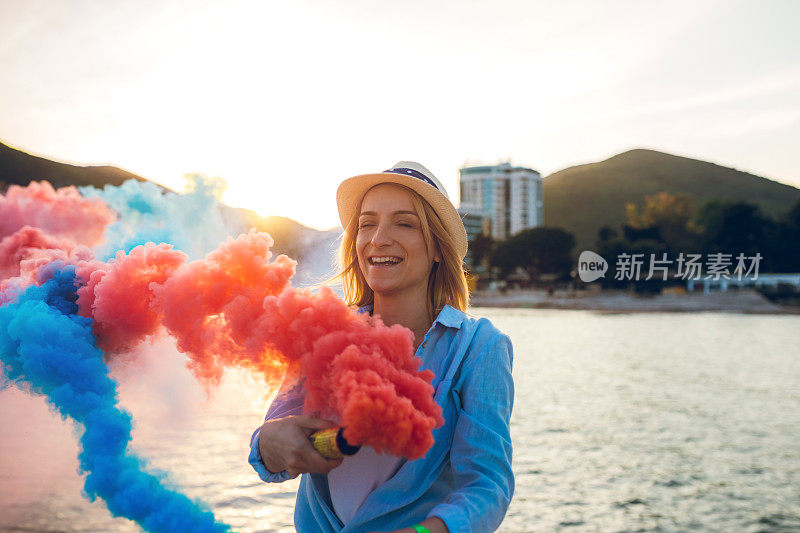 在海滩上玩烟雾弹的女人