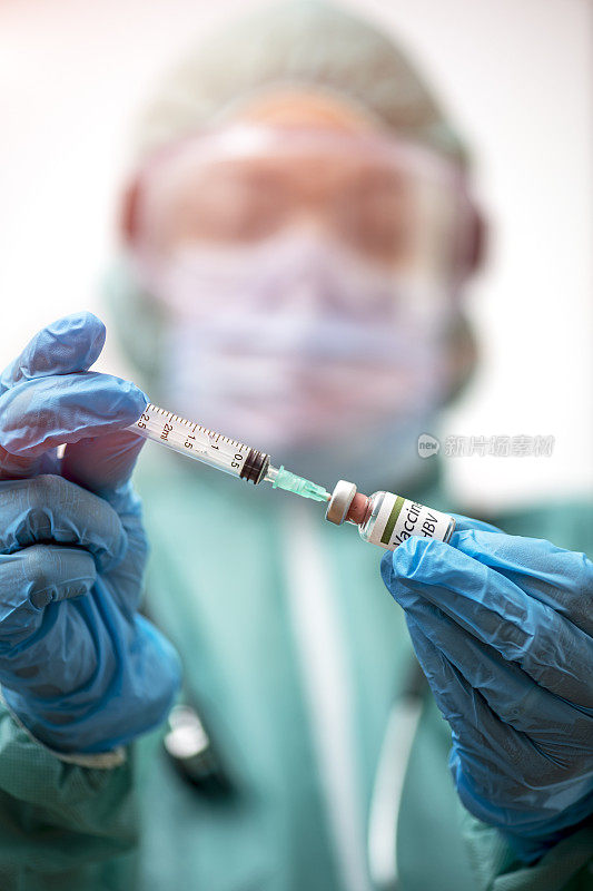 医生戴上防护口罩和手套，正在准备乙型肝炎疫苗
