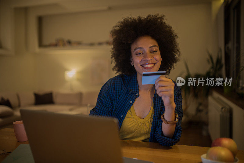 微笑的女人看着信用卡