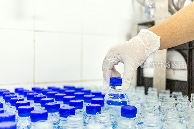 质检员的手水装瓶线处理和装瓶纯饮用水