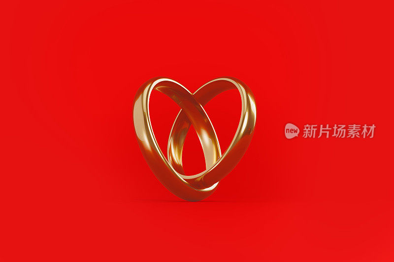 金色的结婚戒指在红色的背景上形成心形