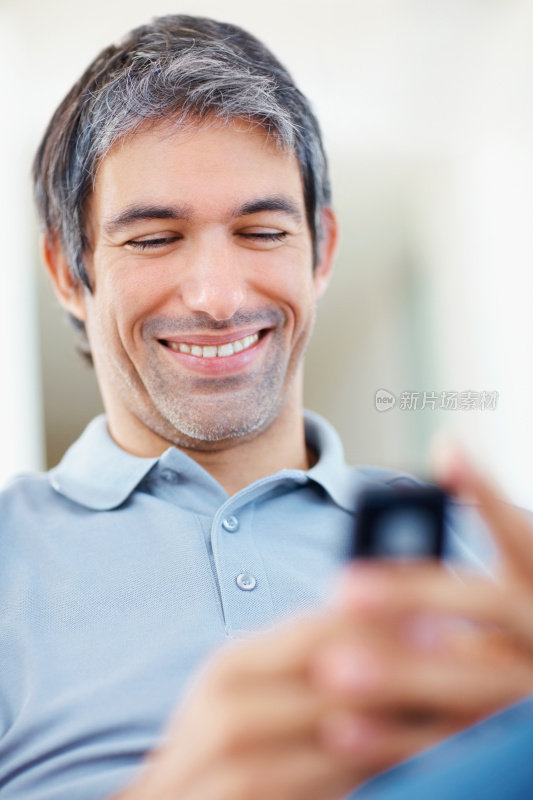 快乐随意男人在手机上看搞笑短信