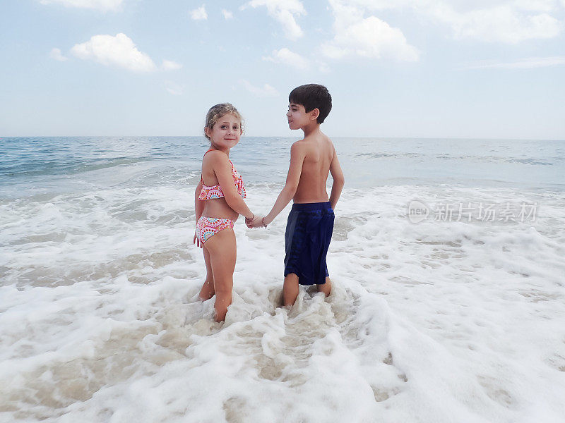 男孩和女孩在冲浪手牵手