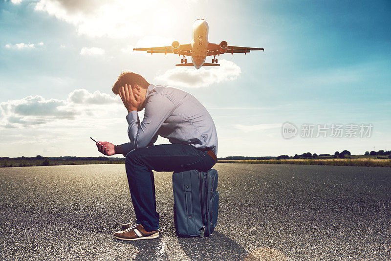 沮丧的乘客一边看手机一边等待飞机