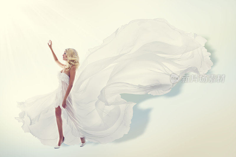 女人飞白色连衣裙，时装模特在飘扬的长袍，织物飞和扑