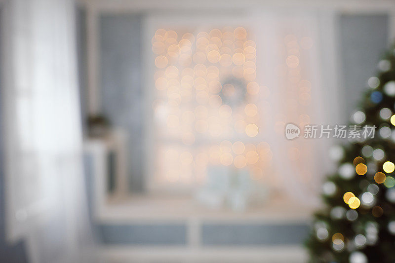 明亮的圣诞室内树，窗户和礼物在散景