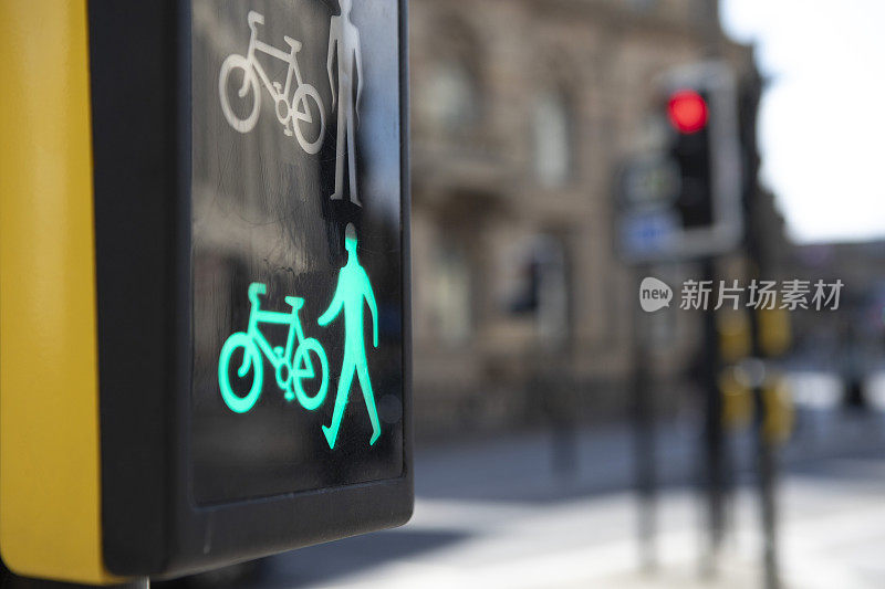 行人和骑车人的十字路口标志-绿色照明，表明可以安全通过，道路交通灯的背景