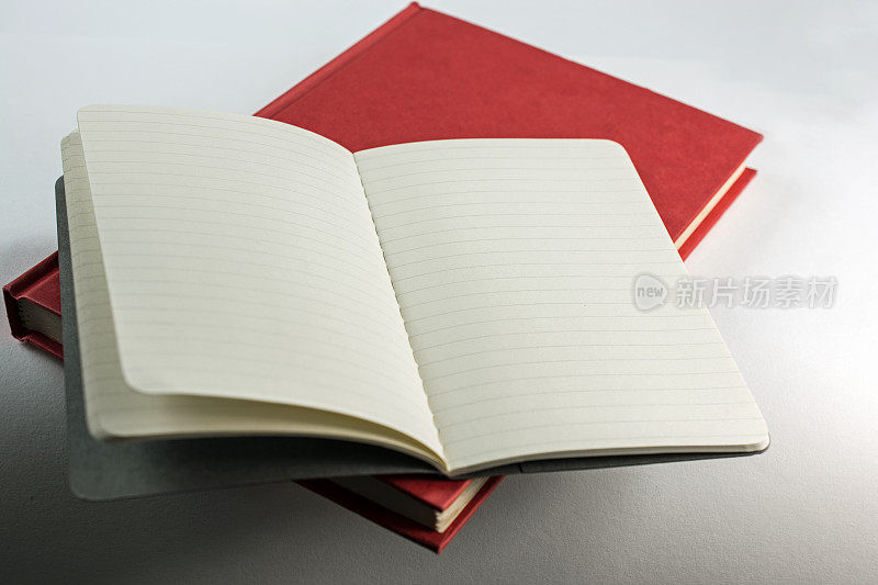 红色封面的书与小笔记本打开，拷贝空间