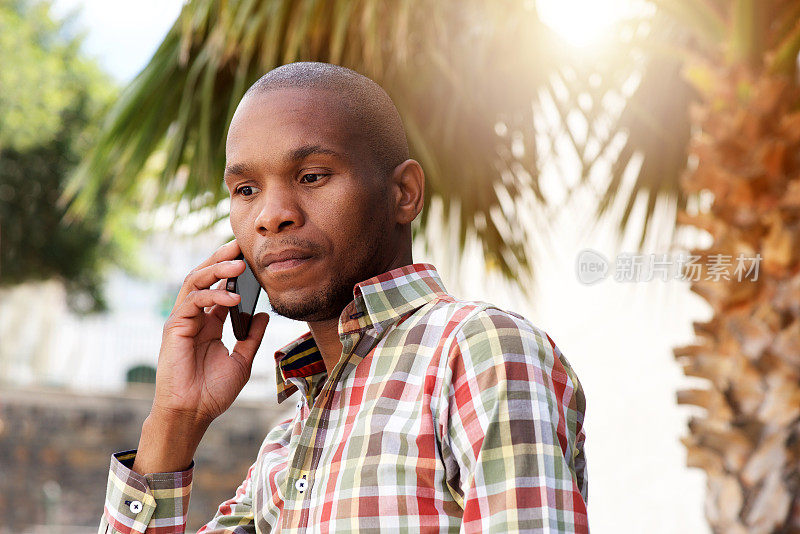 年轻英俊的非洲男人在外面打手机