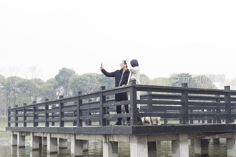 青年男女在木桥上拍照