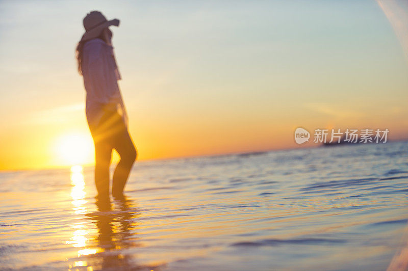 一个女人独自站在海边的水里。