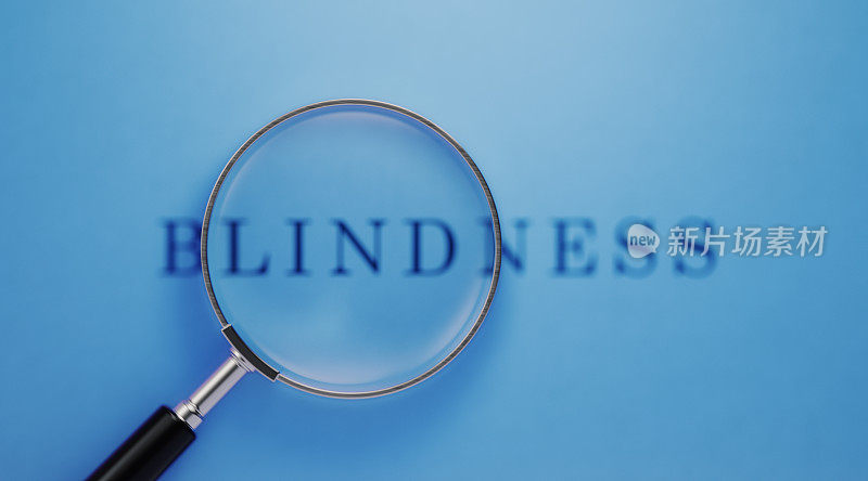视觉和失明的概念-放大镜和失明的文本在蓝色的背景