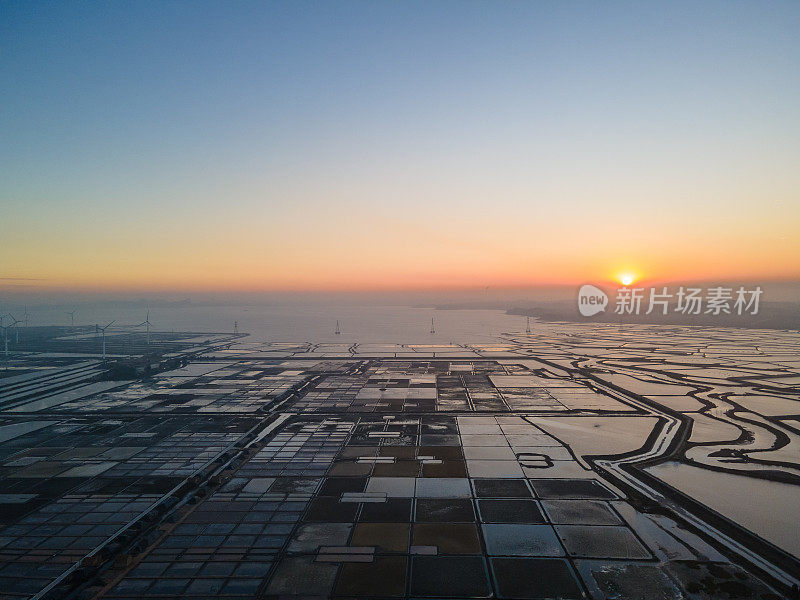 日落时海盐场的鸟瞰图