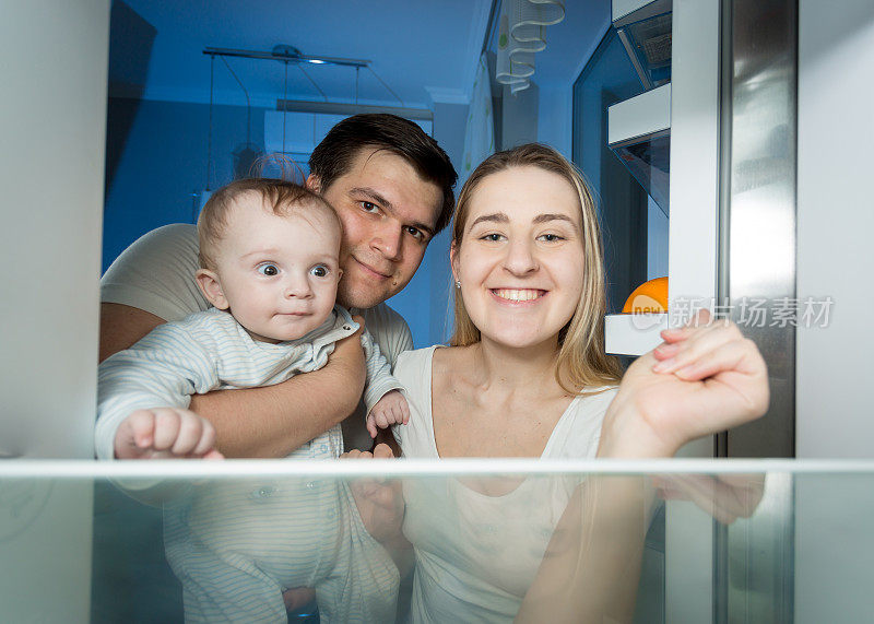 爸爸，妈妈和宝宝往冰箱里看的照片