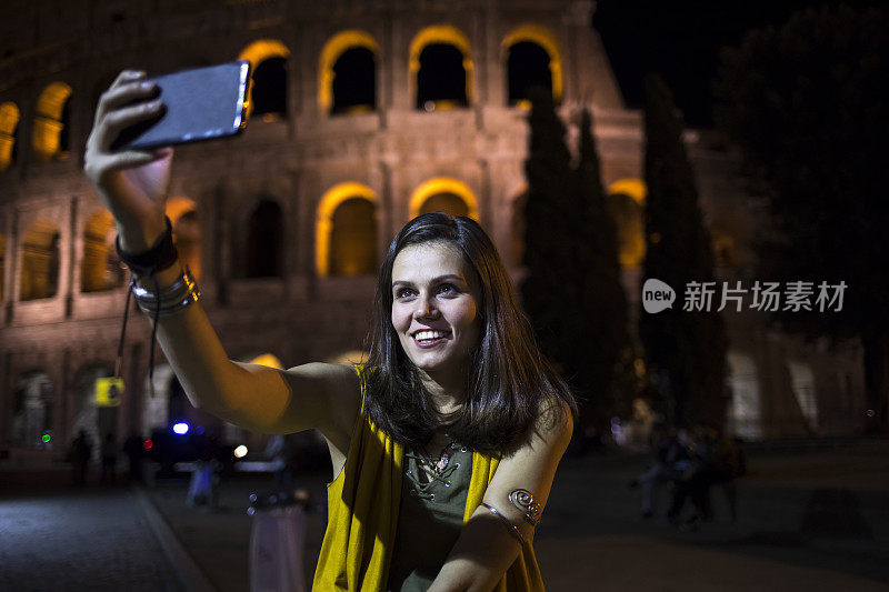 微笑的游客在意大利的夜晚自拍
