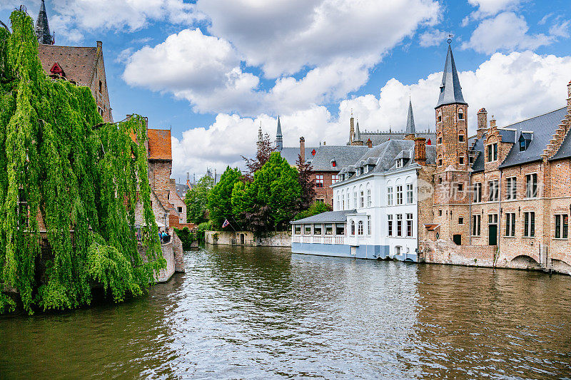 比利时布鲁日的运河:一条传统的砖砌运河的宁静景色，两边都是建筑。