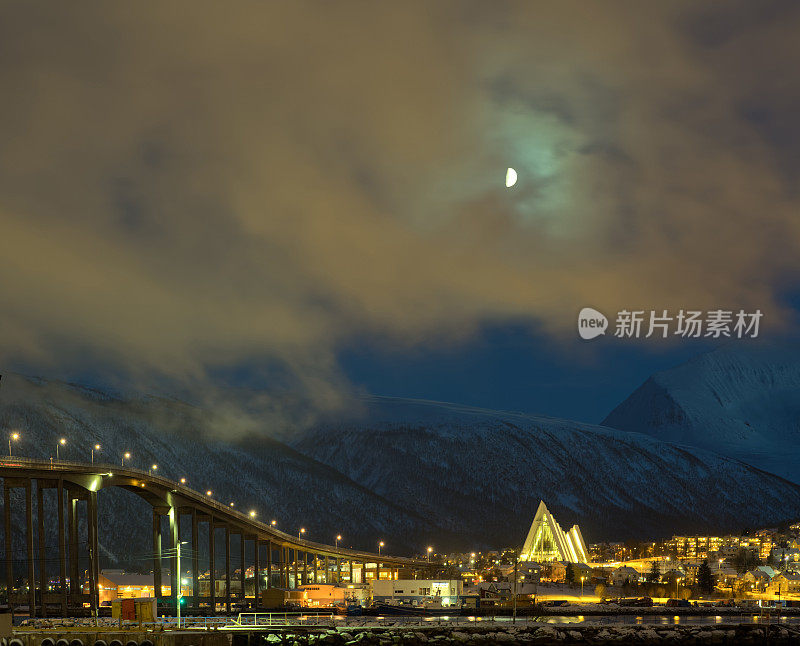 在北极的夜晚，有现代大教堂的特罗姆瑟市灯火通明