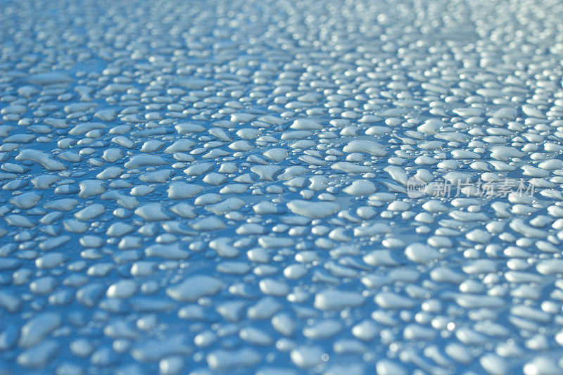 水滴落在锃亮的蓝色发动机罩上