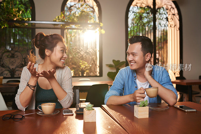 亚洲夫妇在咖啡馆聊天