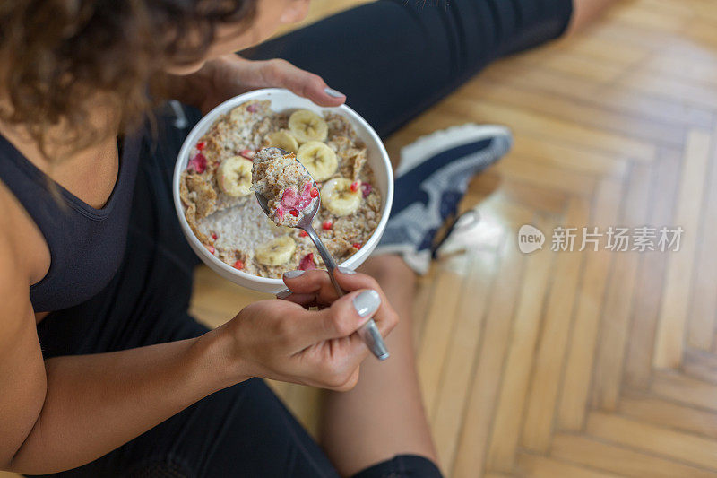 一个年轻女子在锻炼后吃燕麦片