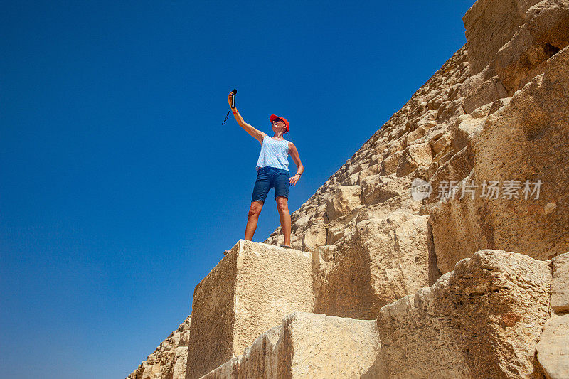 成年女性游客在古奥普金字塔上自拍