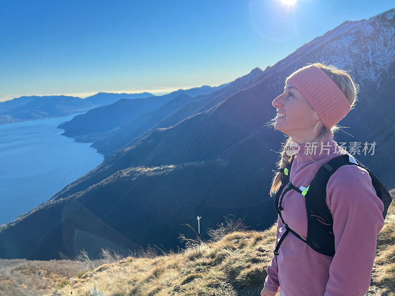 一名年轻女子在瑞士徒步旅行，欣赏令人惊叹的湖景