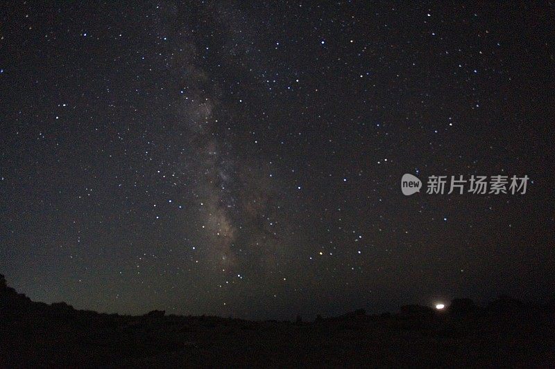 繁星点点的夜空，帐篷，篝火和草地的剪影