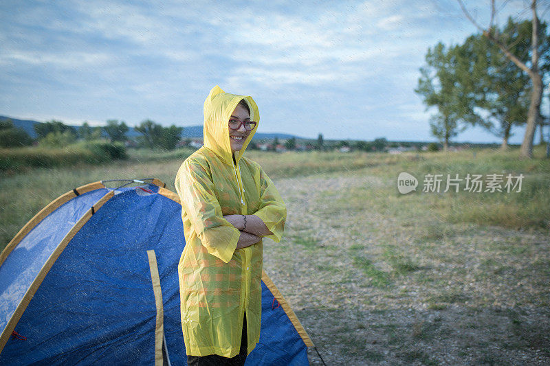 露营者穿着雨衣，在阳光明媚的日子里下雨