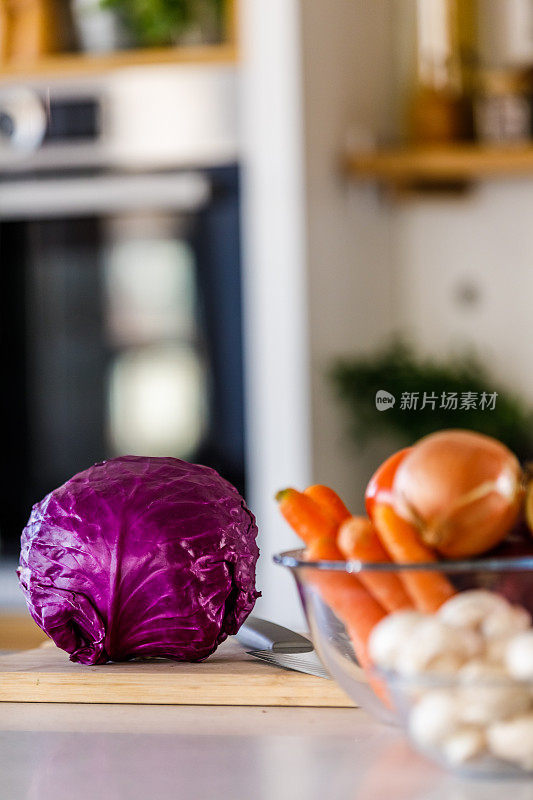 在厨房柜台上复制红色卷心菜、胡萝卜、洋葱和蘑菇的空间照片
