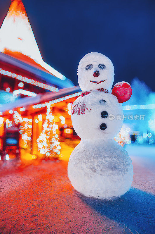 雪圣诞夜的雪人和节日屋