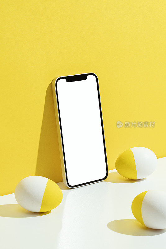 复活节彩蛋和手机模型，模板在黄色和白色的背景