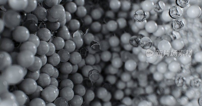 详细的视图展示了黑色和白色的塑料和玻璃球的分散。