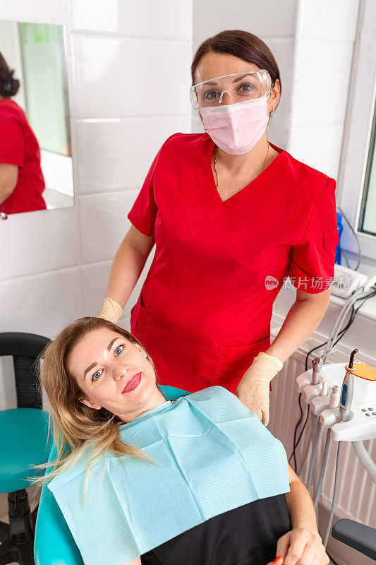一位女牙医正在检查她的病人是否有龋齿。这个女孩会照顾牙齿的健康。美丽，牙齿健康，呵护牙齿。
