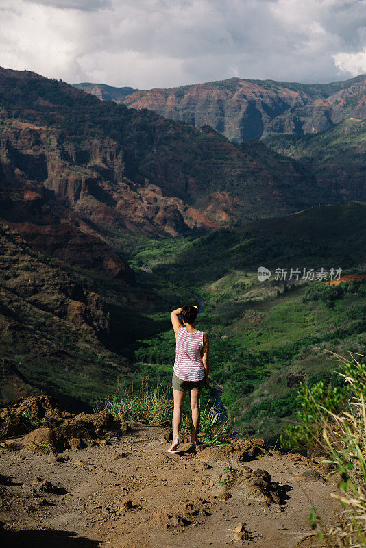 一个女人凝视着风景优美的岩石山谷