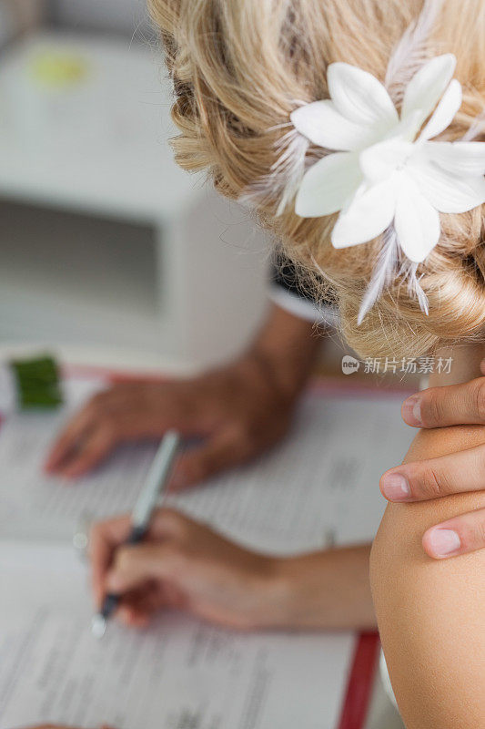 一个迷人的夫妇签名婚礼登记的特写