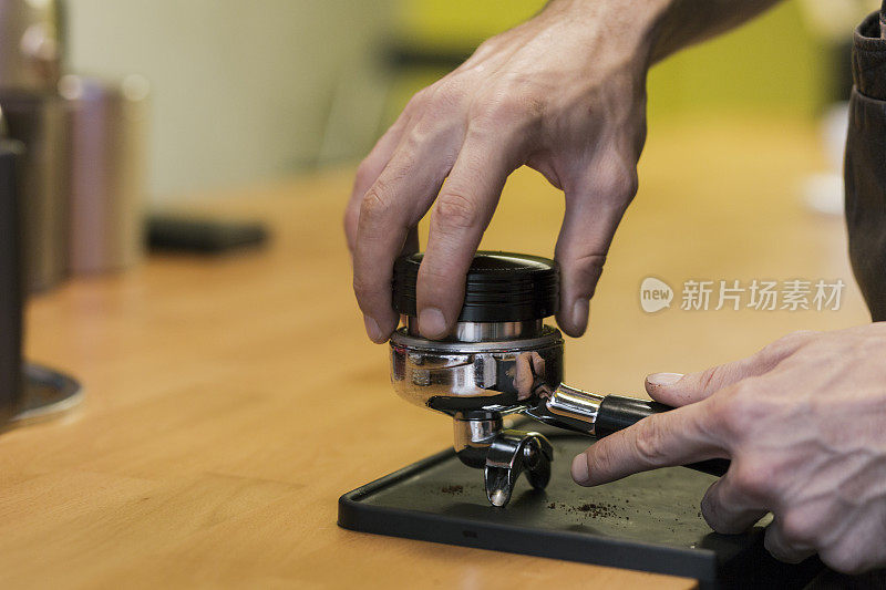 咖啡师夯实咖啡在门滤器的细节视图