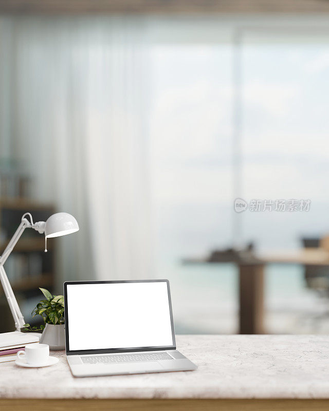 一个现代的家庭办公室，白色大理石桌子上有一台笔记本电脑模型和配件。