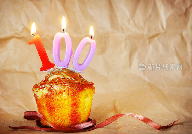 生日蛋糕和燃烧的蜡烛作为第一百