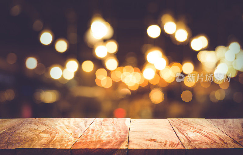 模糊的咖啡馆餐厅木桌与灯光背景