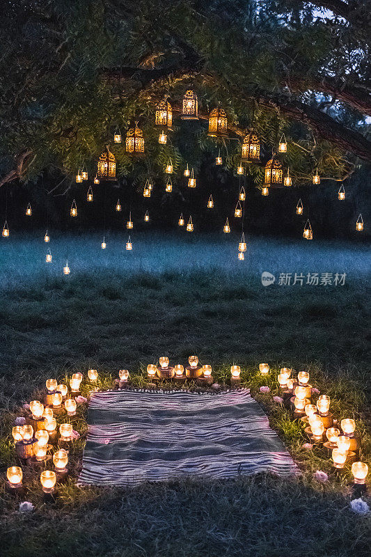 晚上的婚礼仪式用许多复古的灯和蜡烛在大树上