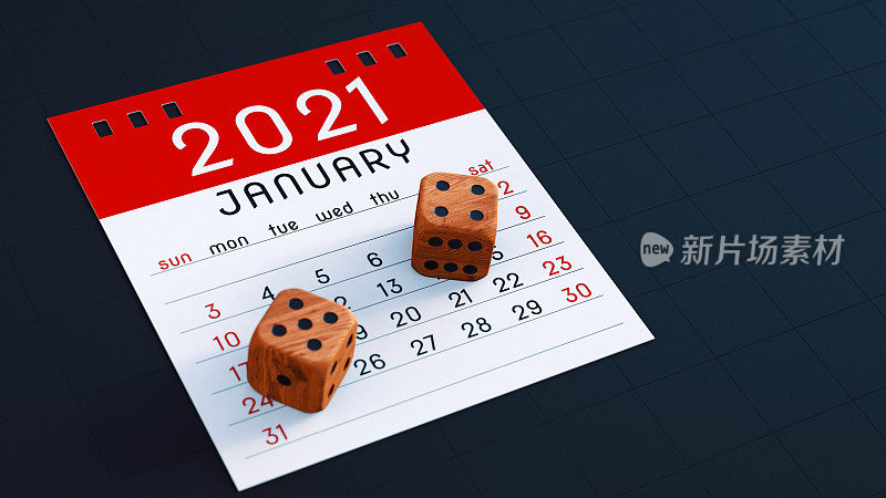木质骰子放置在红色的2021年1月日历记事本页上