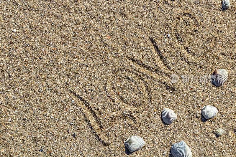 爱的讯息写在沙子上，背景为设计