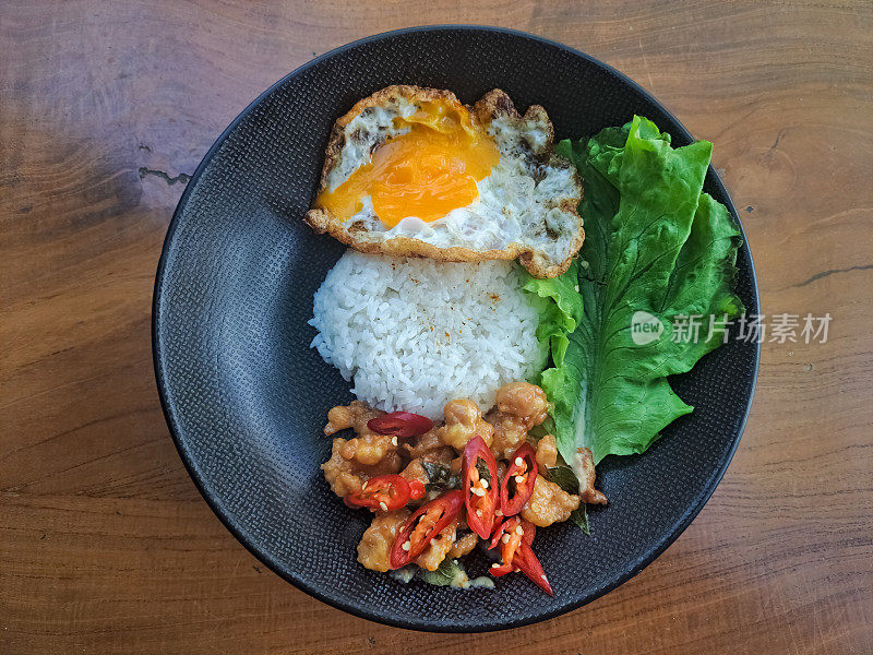 酪乳鸡炒饭，单面朝天，辣椒碎，盐和生菜。食品菜单。前视图。