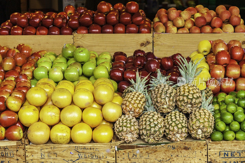 在农贸市场，各种新鲜的苹果、葡萄柚、柠檬、酸橙及菠萝以木盒陈列